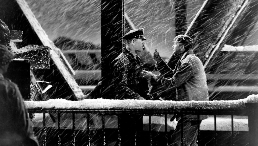 George Bailey confronts Mr. Potter's man on a snowy bridge in It's a Wonderful Life