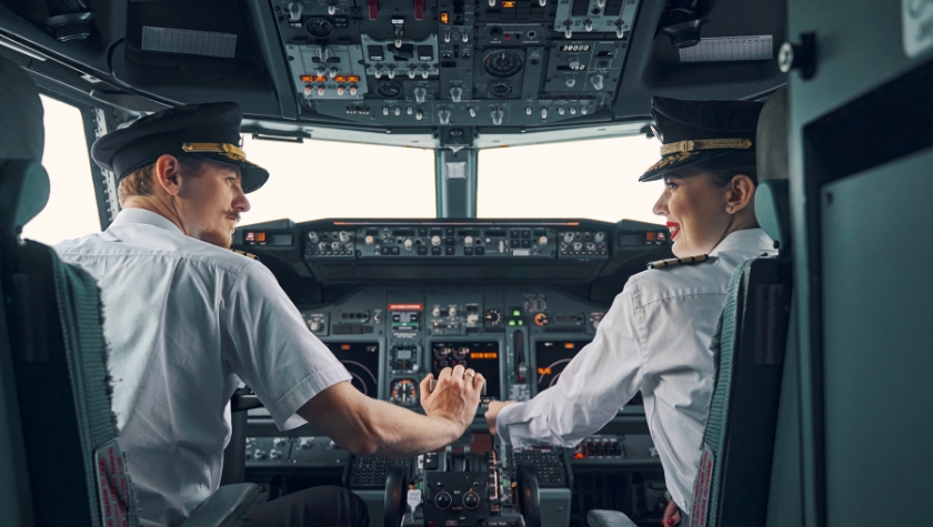 Two pilots collaborating in an airplane cockpit