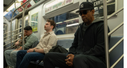Denzel Washington sits on a train in Highest 2 Lowest