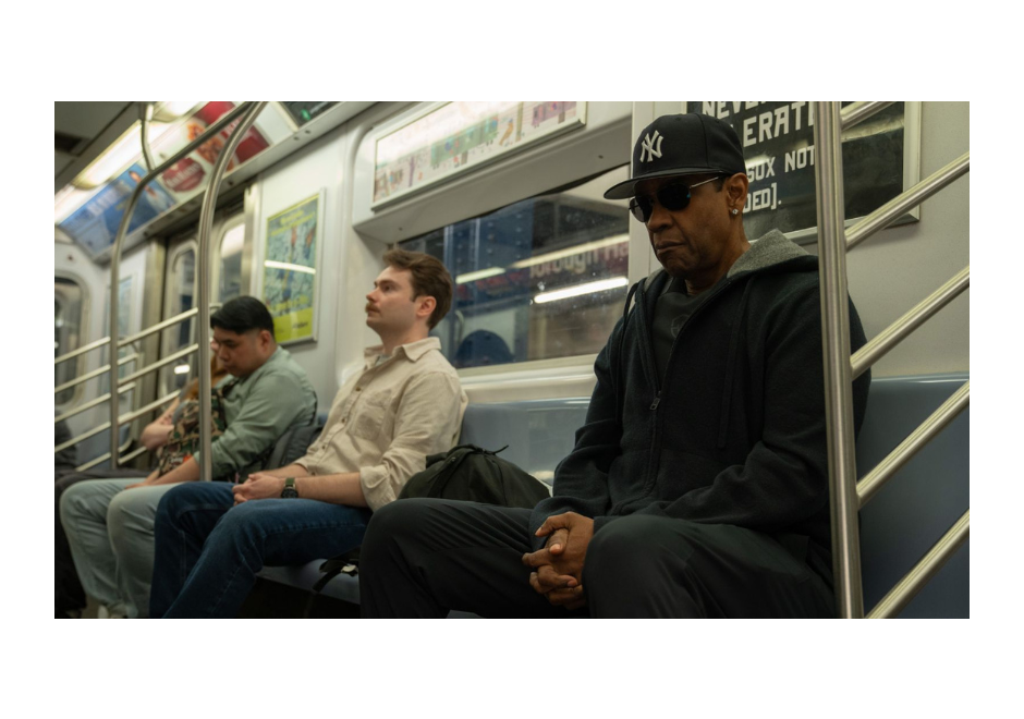 Denzel Washington sits on a train in Highest 2 Lowest