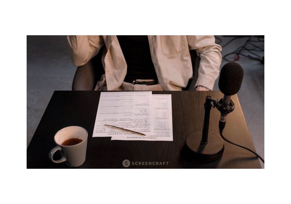 Podcast planning documents on a table next to a microphone