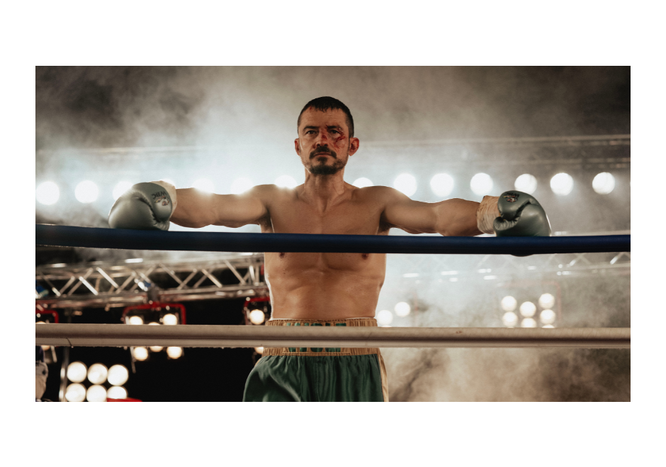 Image of Orlando Bloom leaning against the boxing ring ropes, his face bloodied in 'The Cut'