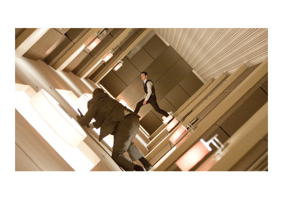 Marvin Campbell crawling on the floor as Joseph Gordon-Levitt steps off the wall onto the ceiling in a revolving room in 'Inception'