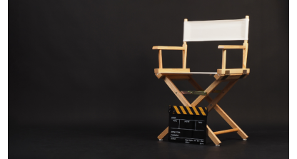White director chair with a clapper board sitting in front of it