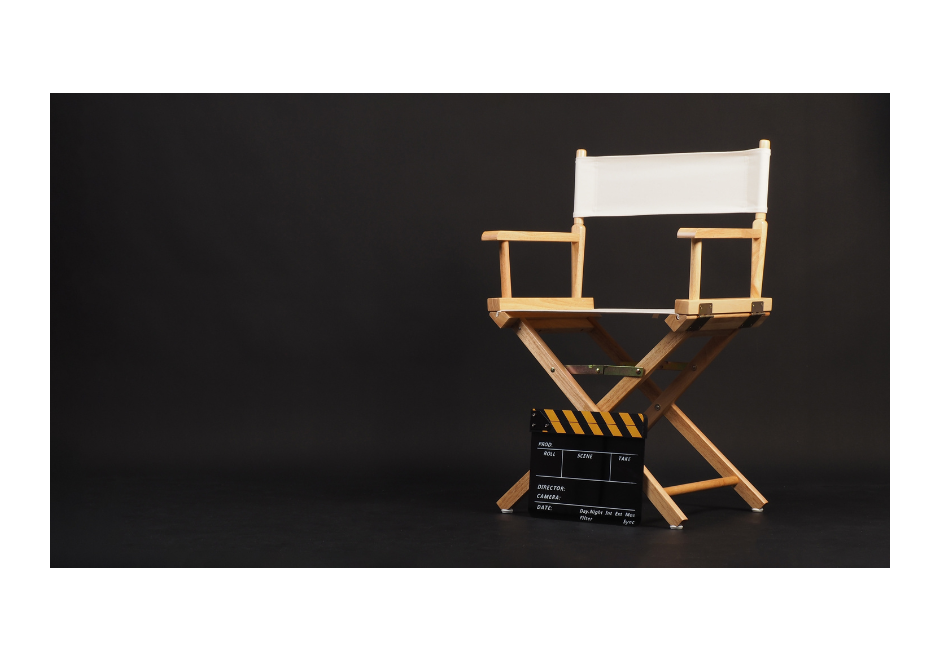 White director chair with a clapper board sitting in front of it