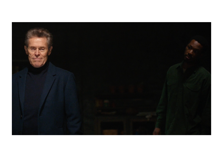 Willem Dafoe looks straight into camera as Corey Hawkins stares at him from the shadows in The Man in My Basement