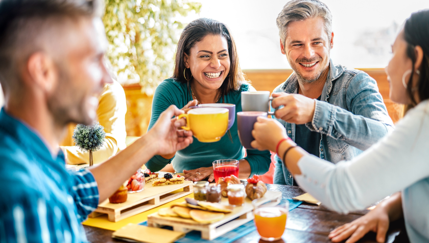 4 friends enjoying charcuterie boards and cheersing 4 coffees