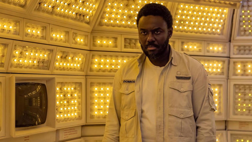Babou Ceesay standing in a white room surrounded by various lights in Alien: Earth