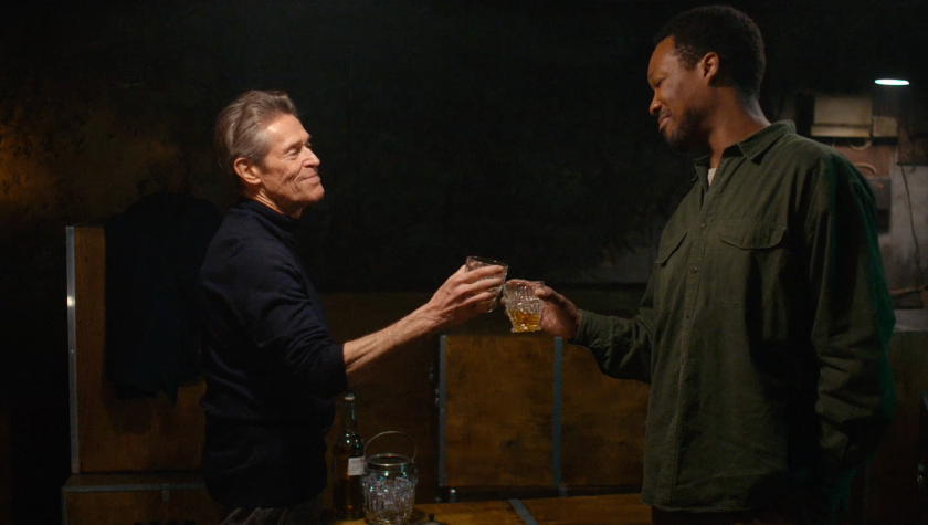 Willem Dafoe and Corey Hawkins cheersing their drinks in The Man in My Basement